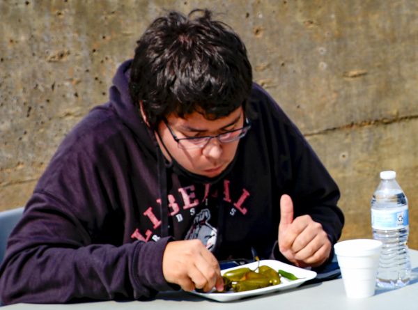 Taking one "for the team," Josh Swanson gobbles down jalapeños as part of the annual pepper eating contest. Swanson was the entrant for Crusader. He said the burning sensation was something he'd never forget.