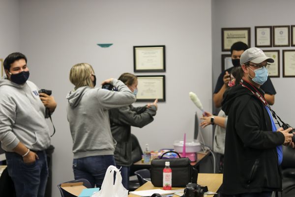 Crusader Staffers photograph the process of making cotton candy. Closely after this photo was taken, the rest of the staff had the opportunity to try their favorite flavor.