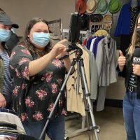 The Crusader staff works together to cover a story over the reopening of the E-boutique. The staff worked on shooting interviews with the members of the PBL club.
